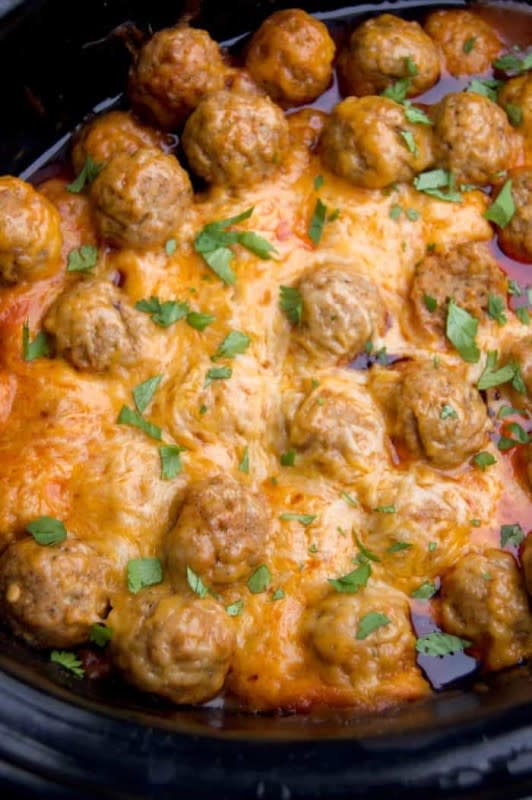 <p>The Diary Of A Real Housewife</p><p>Here is a fun twist on your next Mexican night.</p><p><strong>Get the recipe: <a href="https://www.thediaryofarealhousewife.com/slow-cooker-enchilada-meatballs/" rel="nofollow noopener" target="_blank" data-ylk="slk:Slow Cooker Enchilada Meatballs;elm:context_link;itc:0;sec:content-canvas" class="link rapid-noclick-resp">Slow Cooker Enchilada Meatballs</a></strong></p>