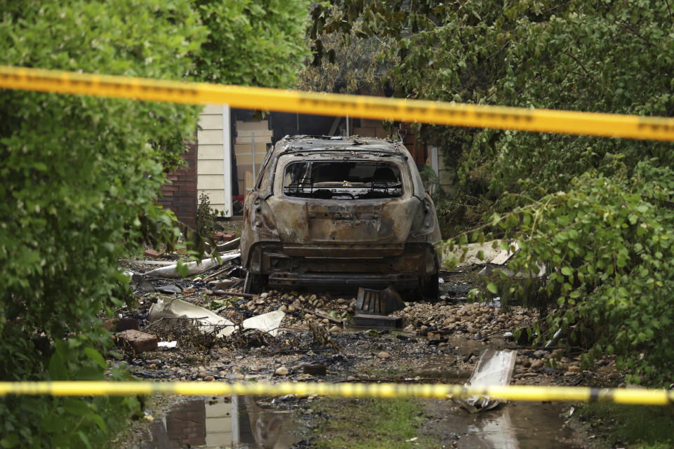 Smoke still rises from the aftermath of a home explosion in unincorporated Lake Zurich, Ill., Wednesday, June 5, 2024. First responders found the home leveled after an explosion about 8:30 p.m. Tuesday according to the Lake County sheriff's office. (Stacey Wescott/Chicago Tribune via AP)