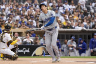 Los Angeles Dodgers' Shohei Ohtani reacts after a swinging strike during the first inning of a baseball game against the San Diego Padres, Saturday, May 11, 2024, in San Diego. (AP Photo/Gregory Bull)