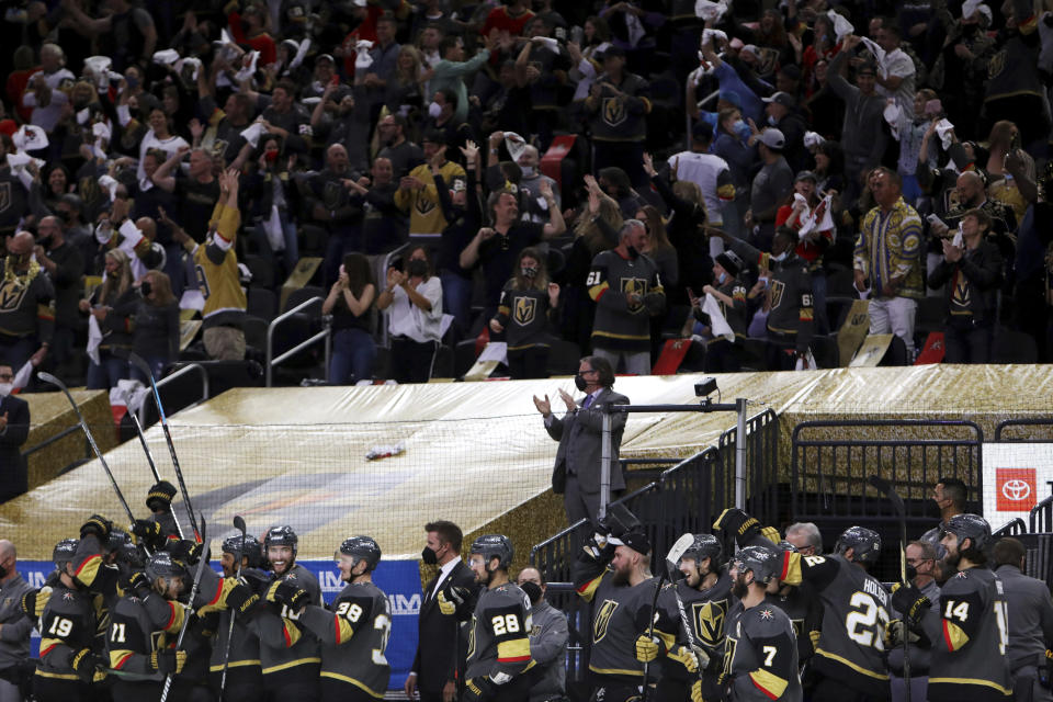 The Vegas Golden Knights bench celebrates the team's final goal against the Minnesota Wild during the third period of Game 7 of an NHL hockey Stanley Cup first-round playoff series Friday, May 28, 2021, in Las Vegas. (AP Photo/Joe Buglewicz)