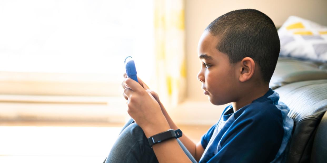 young boy reading on tablet digital devices