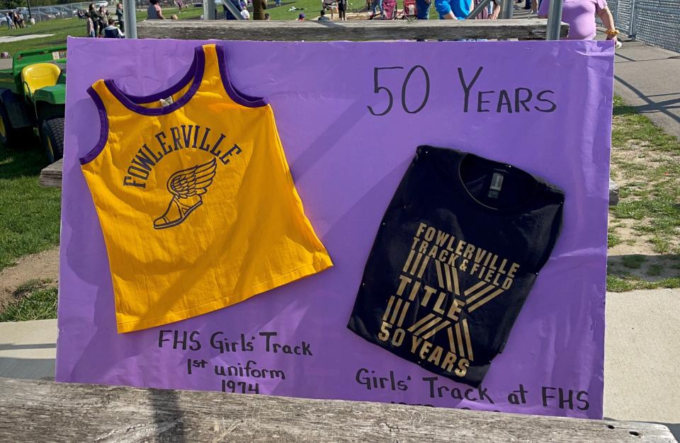 The first jersey worn by Fowlerville's girls track and field team in 1974 is displayed on the left next to a T-shirt worn this year by current runners to commemorate the 50th anniversary of Title IX.