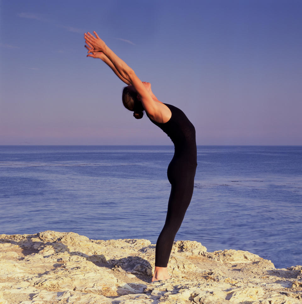 Counter a long day of contracting the back with this powerful back and chest-opening posture. Come to a comfortable standing position with feet hips-width apart, bring your hands up over your head with palms facing forward and thumbs hooked as you bend gently backwards and breathe deeply.  "This is a powerful pose to free up tight chest muscles," Bielkus says.