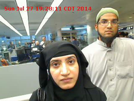 Tashfeen Malik, (L), and Syed Farook are pictured passing through Chicago's O'Hare International Airport in this July 27, 2014 handout photo obtained by Reuters December 8, 2015. REUTERS/US Customs and Border Protection/Handout via Reuters