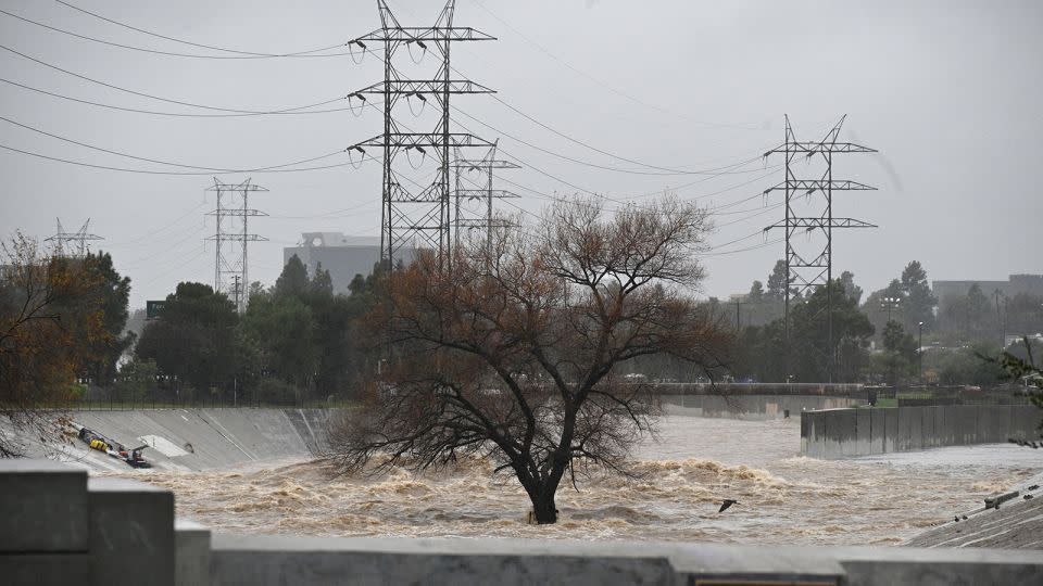 Water rages Monday along the Los Angeles River as the second and more powerful of two atmospheric river storms inundates the city. - Robyn Beck/AFP/Getty Images