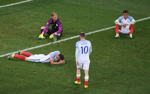 Wayne Rooney, Joe Hart, Gary Cahill, and Dele Alli lie on the turf after the loss  in the last 16 to Iceland in 2016 - Credit: GETTY IMAGES