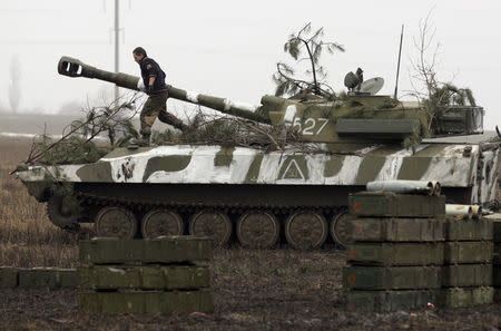 A member of the self-proclaimed Donetsk People's Republic forces walks on top of a self-propelled artillery gun during tactical training exercises in Donetsk region, Ukraine, February 4, 2016. REUTERS/Alexander Ermochenko