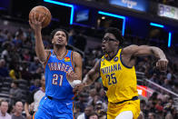 Oklahoma City Thunder guard Aaron Wiggins (21) shoots over Indiana Pacers forward Jalen Smith (25) during the first half of an NBA basketball game in Indianapolis, Friday, March 31, 2023. (AP Photo/Michael Conroy)