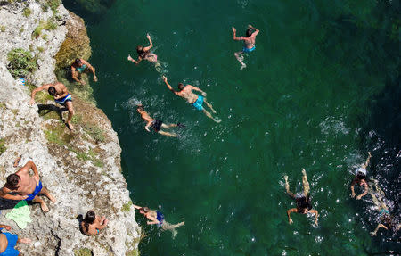 People cool off in the Cijevna river near Tuzi as a heatwave hits Montenegro, August 4, 2017. REUTERS/Stevo Vasiljevic