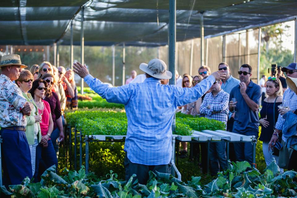 Farmer Darrin Swank, center, addresses guests during a pre-dinner tour at his Swank Farm in Loxahatchee Groves.