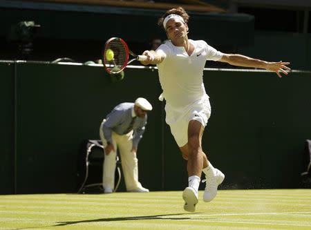 Roger Federer of Switzerland hits a shot during his match against Damir Dzumhur of Bosnia and Herzegovina at the Wimbledon Tennis Championships in London, June 30, 2015. REUTERS/Henry Browne