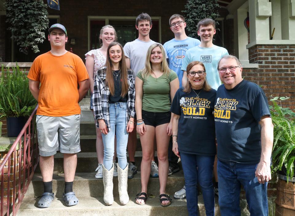 Charlie and Wendy Sommer pose with the seniors on the Cadot High School archery team on the front steps of the SommerÕs home on Eastern Parkway.  Saturday, May 14, 2023Charlie and Wendy Sommer have 15-year friendship that they have struck up with a tiny school in Cadott Wisconsin. Every year about 50 students come to a big archery competition that runs the Saturday after Derby in the expo center. This friendship started because 15 years ago a bus from Cadott pulled in front of Charlie's house in the Highlands, which is home to one of the largest trees on Eastern Parkway. They were sitting on their porch, and began talking with the group, who was on its way to Mark's Feed Store, because it can handle larger crowds. Before the students left the seniors took a picture in front of their sycamore tree -- which is one of the largest trees in the highlands -- and someone shouted "see you next year." Charlie didn't really think anything of it at the time, but then the week after derby the following year the van pulled up blowing its horn excitedly, and the again and the next batch of seniors took another picture in front of this giant tree. That same photo has been taken each year and then published in Cadott's year book year after year for the past 15 years (minus COVID) ... and now they've got this ongoing friendship and the bus comes every year and the Sommers even join them for the meal. They've exchanged many gifts over the years. The coach of the team helps foster this tradition because he believes it's important to teach his students about friendships, and how they can start over the smallest things.