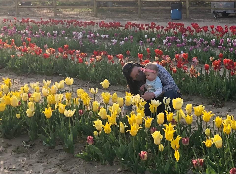 Emily Anastasi and daughter Violet, 1, take in the tulips at Dalton Farms in Swedesboro, NJ. Violet's Trisomy-21 diagnosis has made the issue of mask-wearing a personal one for the Anastasi family.