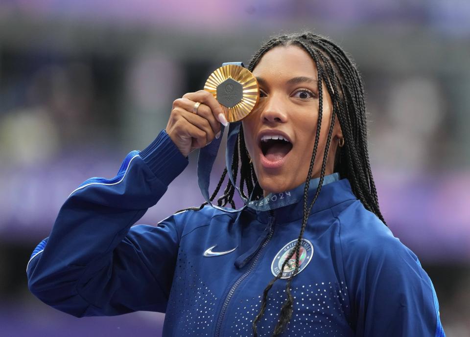 Former Texas athlete Tara Davis-Woodhall celebrates after winning gold in the long jump in the Paris Olympics. Davis-Woodhall was one of 30 former or current Texas athletes competing in the Olympics, and she was among the six that won a gold medal.