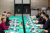 German Chancellor Angela Merkel, left, speaks to Japanese Prime Minister Shinzo Abe, right, at the start of their meeting at Abe's official residence in Tokyo, Japan, Monday, Feb. 4, 2019. (Franck Robichon/Pool Photo via AP)