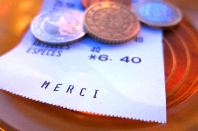 Euros and receipt on table in France.