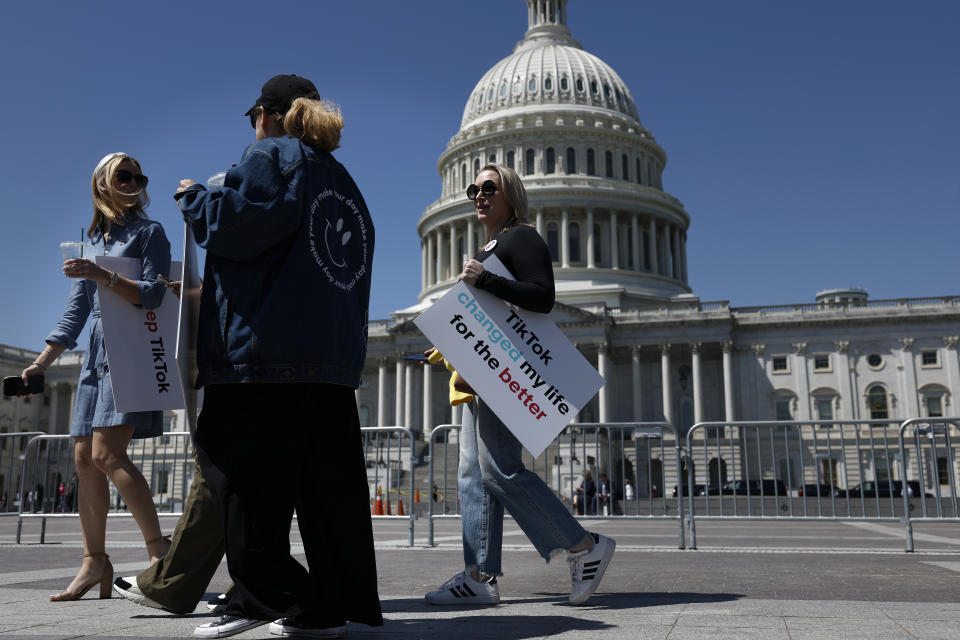 WASHINGTON, DC - APRIL 23: Participants hold signs supporting TikTok as they walk on the East Front Plaza of the US Capitol Building on April 23, 2024 in Washington, DC.  The Senate is taking up a $95 billion foreign aid package today for Ukraine, Israel and Taiwan, including legislation that would require the Chinese owner to sell TikTok or ban the app in the United States.  (Photo by Anna Moneymaker/Getty Images)