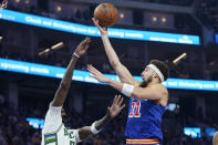 Golden State Warriors guard Klay Thompson (11) shoots against Milwaukee Bucks center Bobby Portis Jr. during the first half of an NBA basketball game in San Francisco, Saturday, March 12, 2022. (AP Photo/Jeff Chiu)