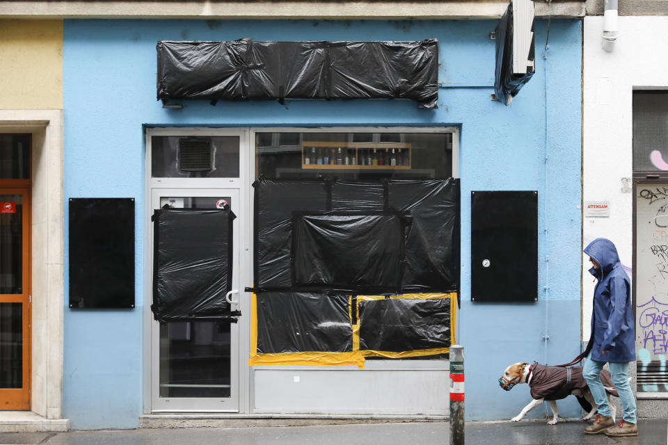 The former beer shop belonging to the man who recently shot his former girlfriend in Vienna, Austria, Friday, May 14, 2021. The glass front is taped up in black foil since it was smashed after the murder. A memorial for Nadine, a woman who was killed on April 5 by her former partner, is set up at the on the Yppenplatz square in Vienna, Austria, Friday, May 14, 2021. Austria is one of the few European Union countries where the number of women killed is higher than the number of men. The recent high-profile cases have led to widespread protests, demands for government intervention and condemnations from top politicians. (AP Photo/Lisa Leutner)