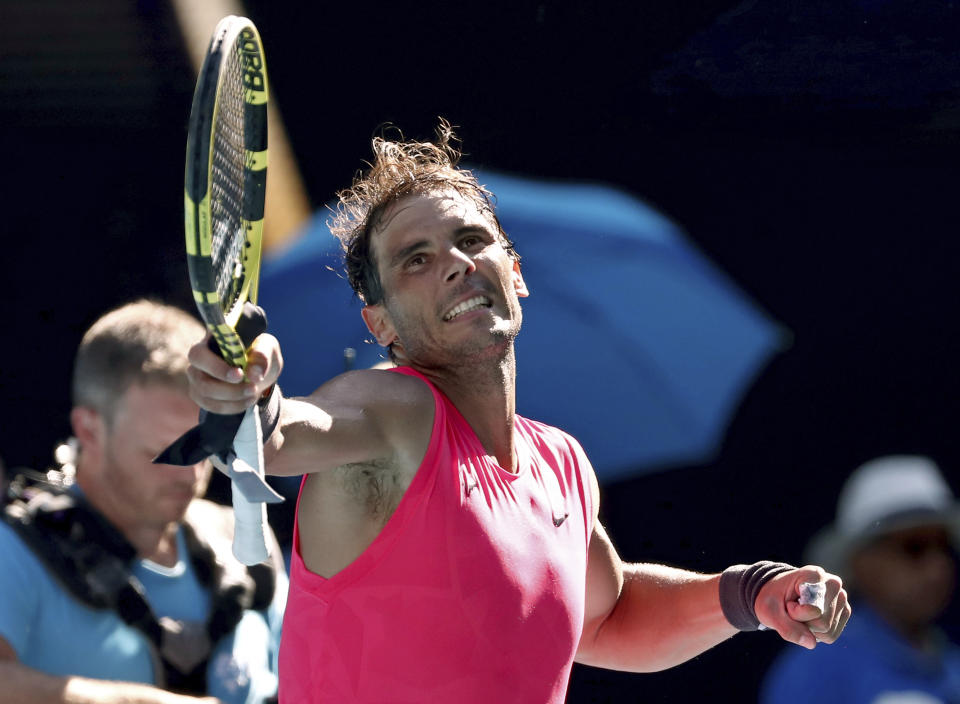 Spain's Rafael Nadal celebrates after defeating compatriot Pablo Carreno Busta during their third round singles match at the Australian Open tennis championship in Melbourne, Australia, Saturday, Jan. 25, 2020. (AP Photo/Dita Alangkara)