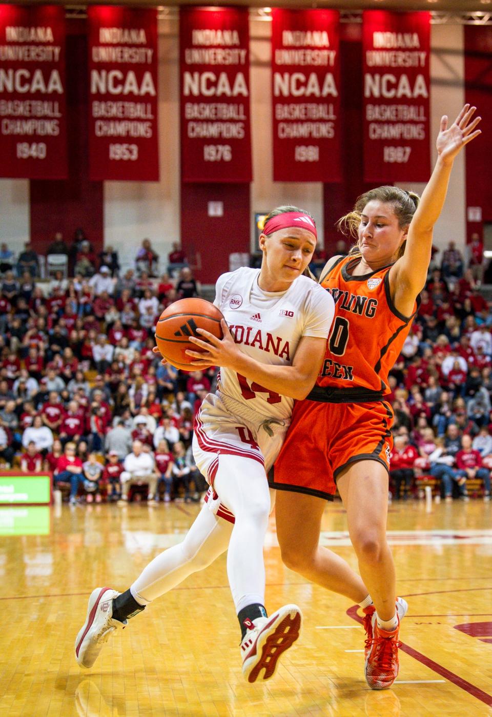 Indiana's Sara Scalia (14) drives past Bowling Green's Morgan Sharps (0) during the first half of the Indiana versus Bowling Green women's basketball game at Simon Skjodt Assembly Hall on Friday, December 22, 2023.