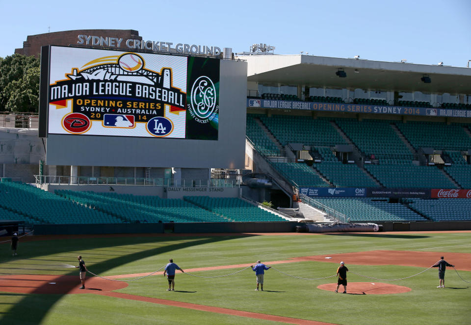 Ground staff prepare the baseball field that has been especial built for the Major League Baseball opening series at the Sydney Cricket Ground in Sydney, Monday, March 17, 2014. The MLB season-opening two-game series between the Los Angeles Dodgers and Arizona Diamondbacks in Sydney will be played this weekend. (AP Photo/Rick Rycroft)