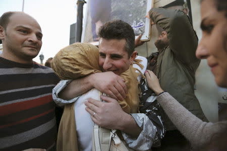 A newly released policeman, who was captured by the al Qaeda-linked Nusra Front in Arsal, embraces his relative during a celebration outside the government palace in downtown Beirut, December 1, 2015. REUTERS/Aziz Taher