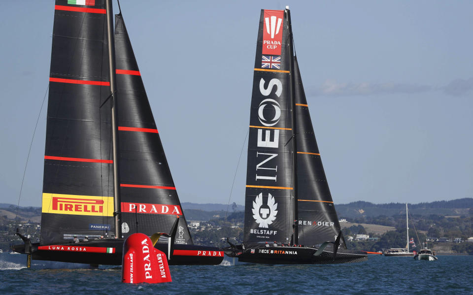 Britain's INEOS Team UK, right, leads Italy's Luna Rossa to win race six of the Prada Cup on Auckland's Waitemata Harbour, New Zealand, Saturday, Feb. 20, 2021. (Dean Purcell/NZ Herald via AP)