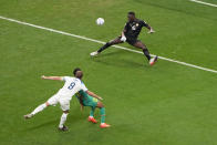 England's Harry Kane, left, scores his side's 2nd goal during the World Cup round of 16 soccer match between England and Senegal, at the Al Bayt Stadium in Al Khor, Qatar, Sunday, Dec. 4, 2022. (AP Photo/Ariel Schalit)