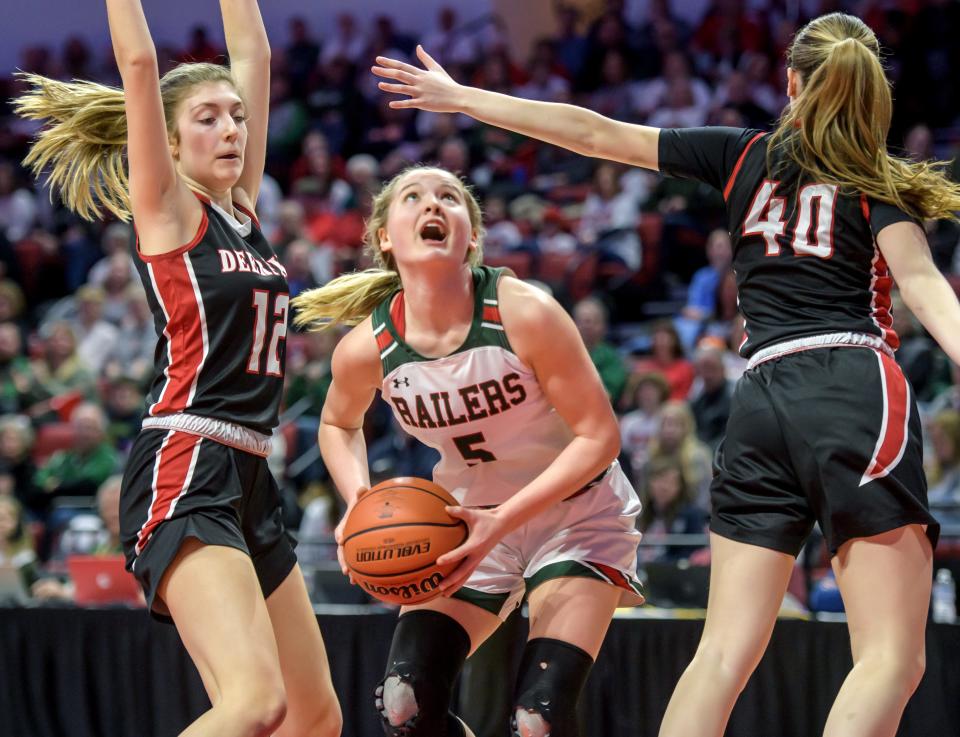 Lincoln's Kloe Froebe (5) looks for an opening between Deerfield's Kate Trella (12) and Morgan Kerndt in the firsthalf of the Class 3A state semifinals Friday, March 3, 2023 at CEFCU Arena in Normal. The Railers advanced to the title game with a 76-56 win over the Warriors.