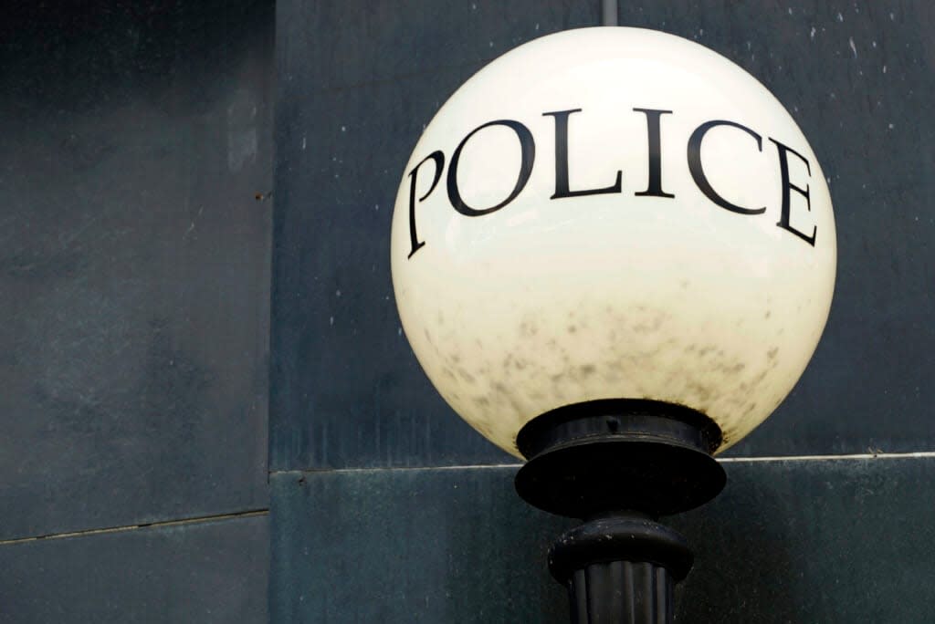 A lamp shines outside police headquarters in Greensboro, N.C., on Wednesday, June 22, 2022. The city recently let lapse its contract for Fog Reveal, a powerful cellphone-tracking tool that some advocates fear violates people’s privacy rights. (AP Photo/Allen G. Breed)