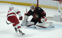 Carolina Hurricanes right wing Andrei Svechnikov, left, scores the shootout winner against Ottawa Senators goaltender Matt Murray during NHL hockey game action Thursday, Jan. 27, 2022, in Ottawa, Ontario. (Adrian Wyld/The Canadian Press via AP)