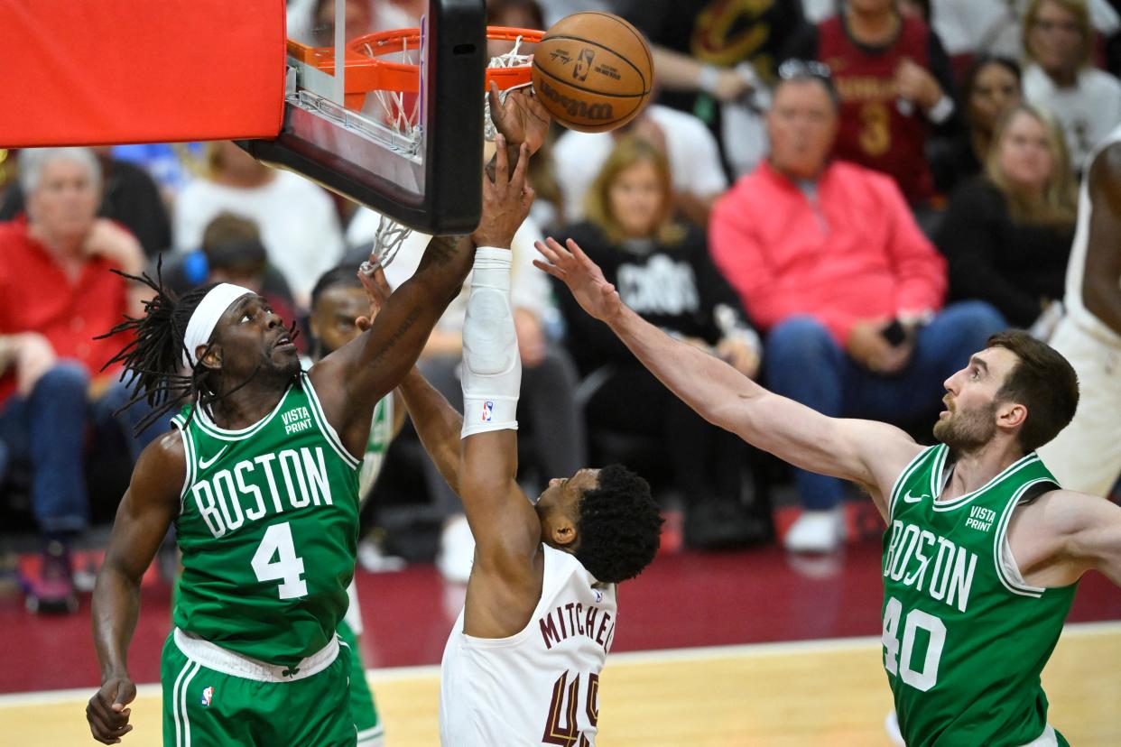 Cavaliers guard Donovan Mitchell shoots the ball against pressure by Celtics guard Jrue Holiday (4) and center Luke Kornet in the third quarter of Game 3 of the Eastern Conference semifinals, May 11, 2024, in Cleveland.