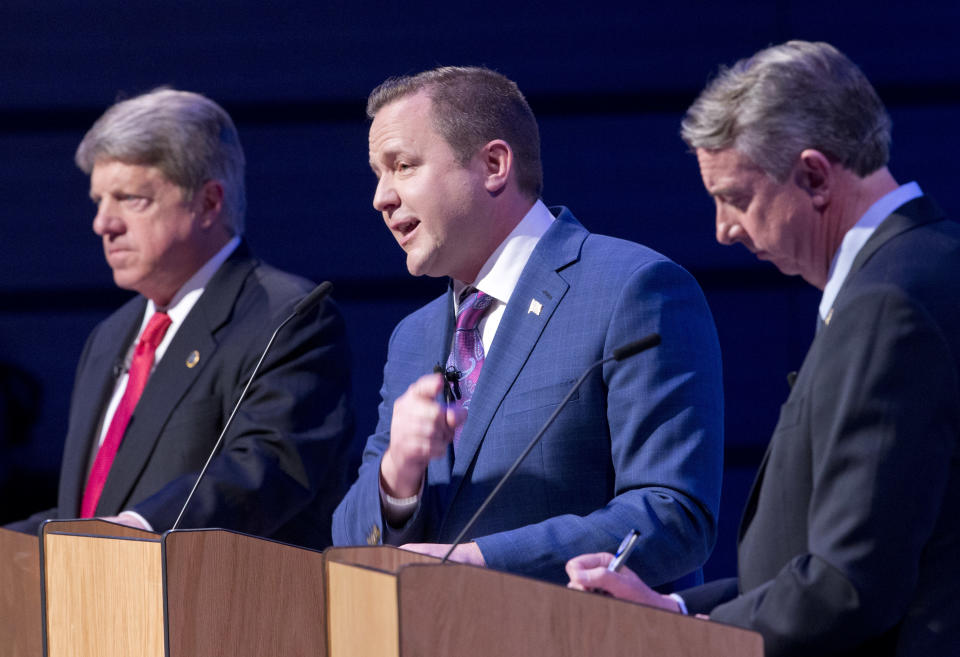 Republican gubernatorial candidate Ed Gillespie, right, and State Sen. Frank Wagner, left, listen as Corey Stewart, center, speaks during a debate at Liberty University in Lynchburg, Va., Thursday, April 13, 2017. (AP Photo/Steve Helber)