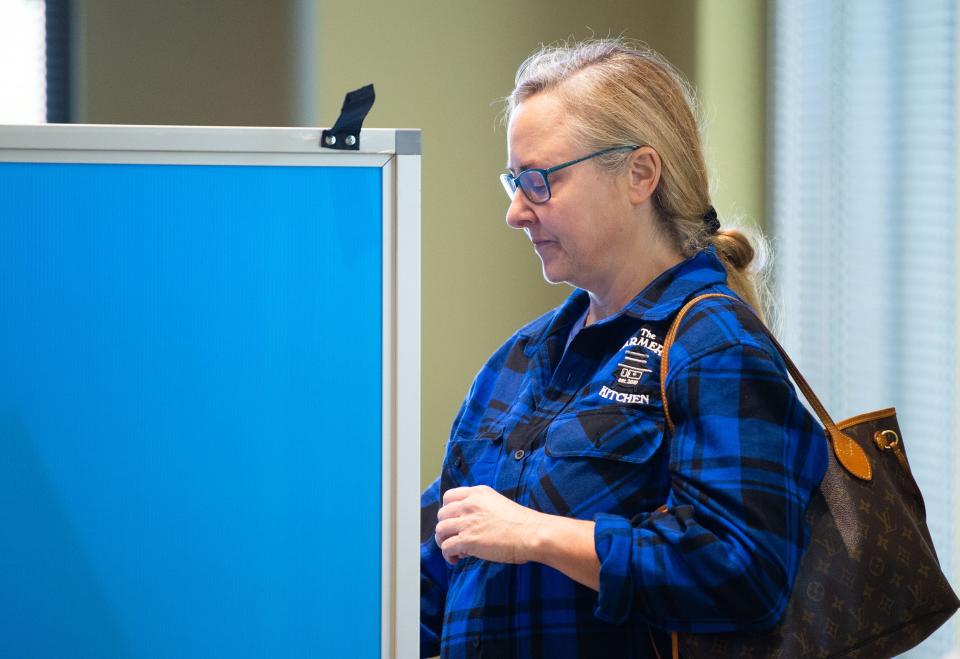 Jennifer Peppers casts her vote behind the booth, Tuesday, Oct. 26, 2021, at the Williamson County Enrichment Center in Franklin. Voting is underway in Williamson County for the Aug. 4, 2022, countywide elections.