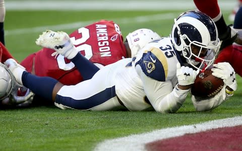 Los Angeles Rams running back C.J. Anderson (35) falls into the end zone for a touchdown against the Arizona Cardinals during the first half of an NFL football game - Credit: AP