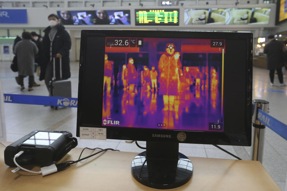 A thermal camera monitor shows the body temperature of people at the Seoul Railway Station in Seoul, South Korea, Friday, Feb. 21, 2020. South Korea reported 100 new virus cases Friday, bringing the country's total to 204, many of them clustered around a southeastern city, and raising fears that the outbreak is getting out of control. (AP Photo/Ahn Young-joon)