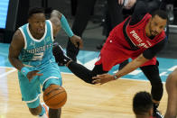 Charlotte Hornets guard Terry Rozier drives past Portland Trail Blazers forward Norman Powell during the second half in an NBA basketball game on Sunday, April 18, 2021, in Charlotte, N.C. (AP Photo/Chris Carlson)