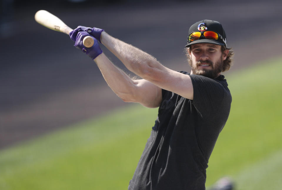 Colorado Rockies left fielder David Dahl warms up before a baseball game against the Texas Rangers Friday, Aug. 14, 2020, in Denver. (AP Photo/David Zalubowski)