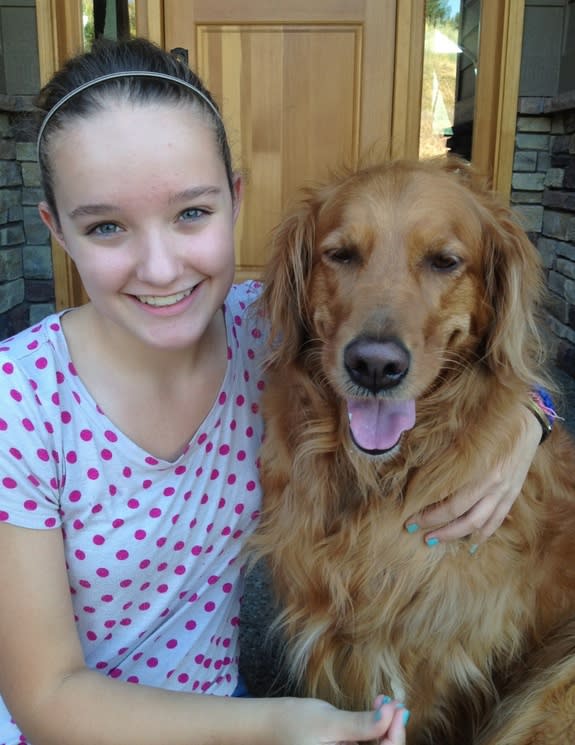 Brooke Martin, 13, was inspired by her dog Kayla (both shown here) to invent iCUPpooch, a device that allows video chat and treat dispensing remotely to keep separation anxiety at bay.