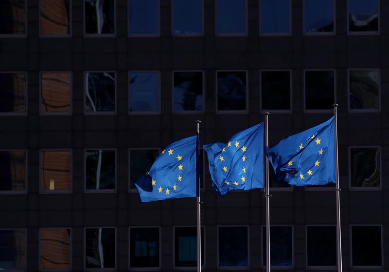 FILE PHOTO: European Union flags fly outside the European Commission headquarters in Brussels