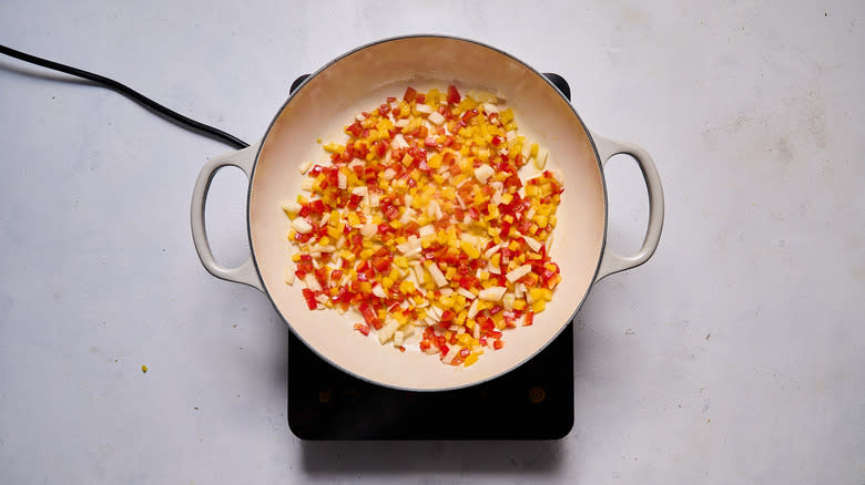 diced pepper and onion cooking in pot