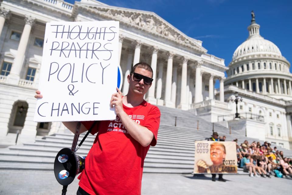 <div class="inline-image__title">1241205512</div> <div class="inline-image__caption"><p>A demonstrator holds a sign referencing calls for legislation to address gun violence outside the U.S. Capitol.</p></div> <div class="inline-image__credit">Tom Williams/Getty Images</div>