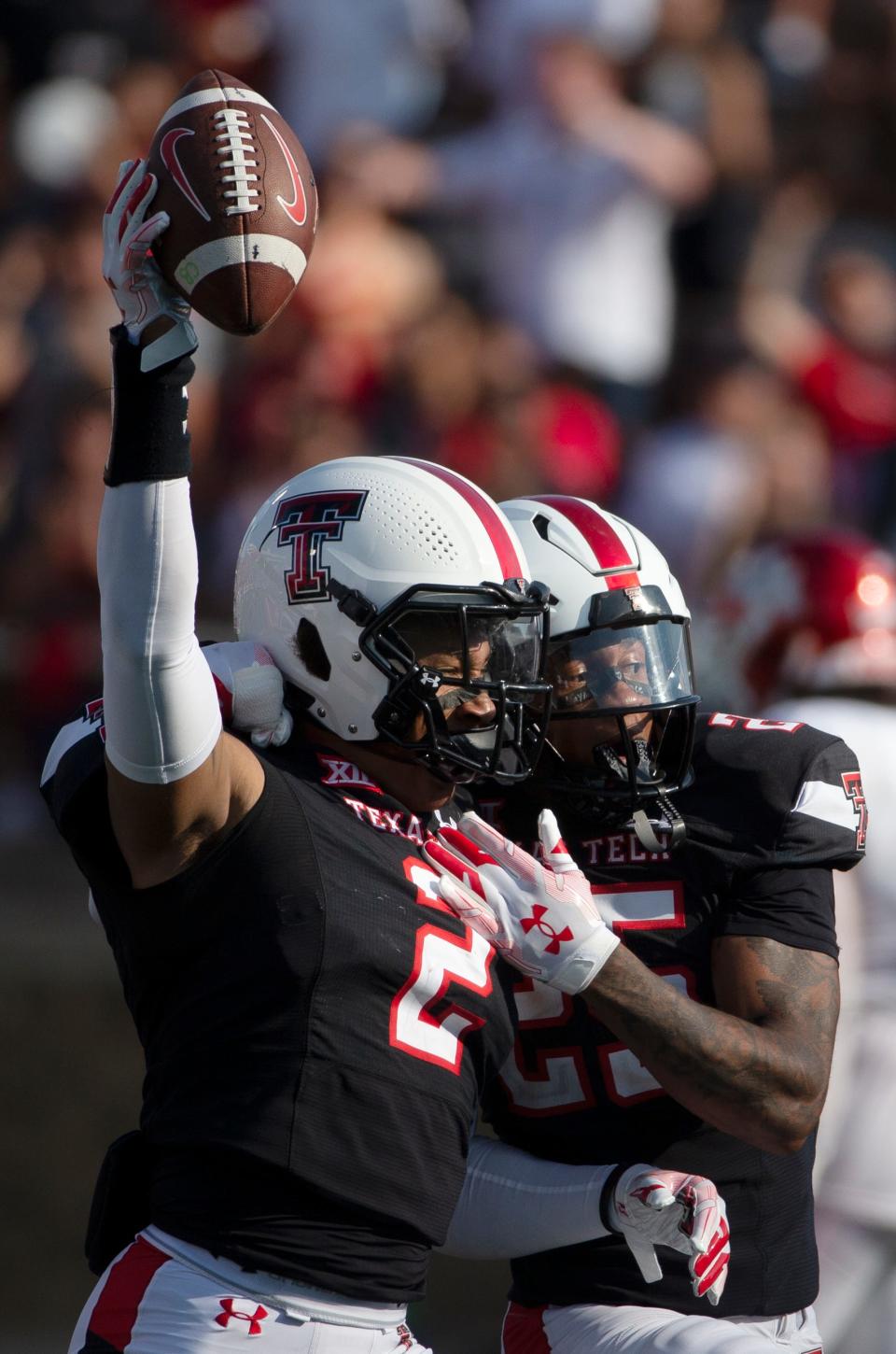 Texas Tech safeties Reggie Pearson (2) and Dadrion Taylor-Demerson celebrate Pearson's interception during the Red Raiders' 33-30 victory in double overtime Saturday against Houston at Jones AT&T Stadium.