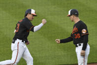 Baltimore Orioles' Austin Hays (21) is greeted by third base coach Tony Mansolino (36) after hitting a first-inning home run against New York Yankees starting pitcher Corey Kluber during a baseball game on Friday, May 14, 2021, in Baltimore. (AP Photo/Terrance Williams)