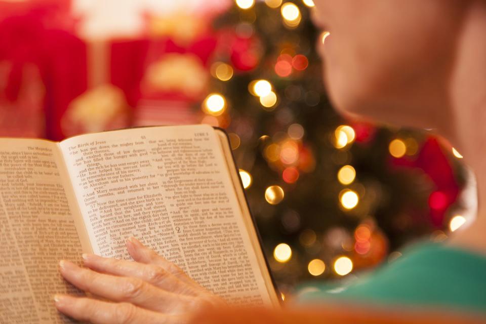 woman reads christmas story from the bible