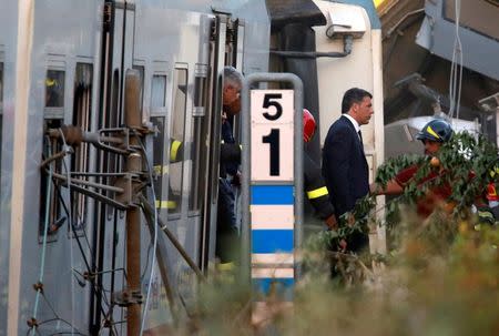 Italian Prime Minister Matteo Renzi walks at the site where two passenger trains collided in the middle of an olive grove in the southern village of Corato, near Bari, Italy, July 12, 2016. REUTERS/Alessandro Garofalo