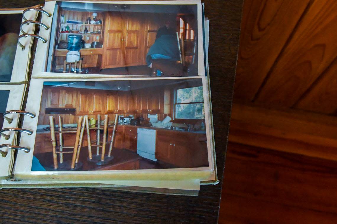 A photo album, this page turned to the kitchen, sits on a table for guests to page through in the living room photographed on Nov. 14, 2022 at Ted Turner’s former St. Phillips Island home.