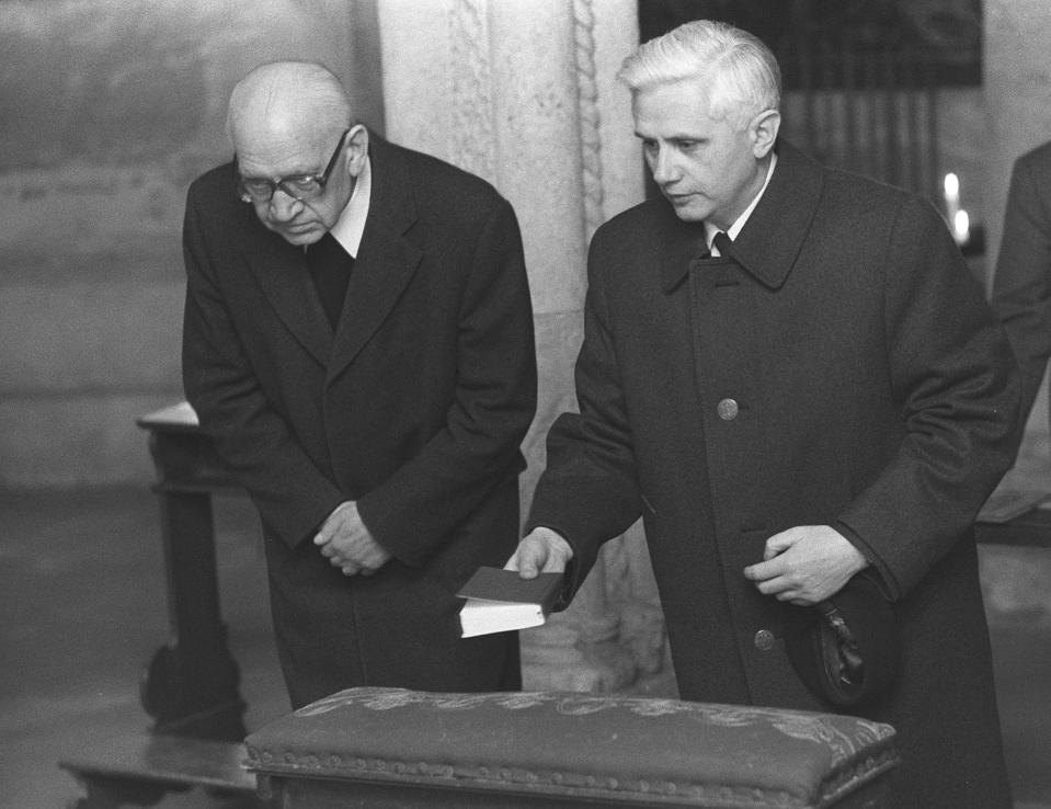 FILE - Newly nominated Archbishop of Munich and Freising, Joseph Ratzinger, right, prays with Bishop Erns Tewes in the Crypta of the Cathedral of Freising, southern Germany on March 31, 1977. Ratzinger went on to become Pope Benedict XVI. Pope Emeritus Benedict XVI, the German theologian who will be remembered as the first pope in 600 years to resign, has died, the Vatican announced Saturday. He was 95. (AP Photo/Dieter Endlicher, File)