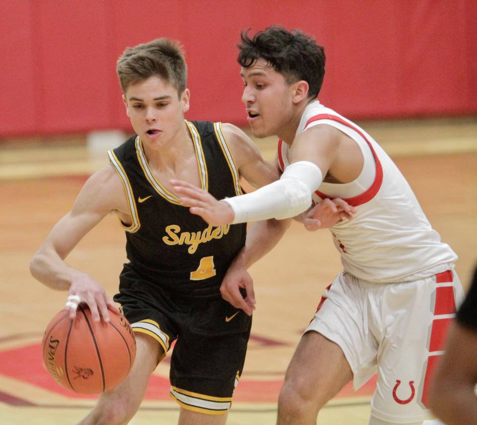 Snyder's Hunter Stewart dribbles past Sweetwater's Armando Torres on Tuesday, Jan. 18, 2022.